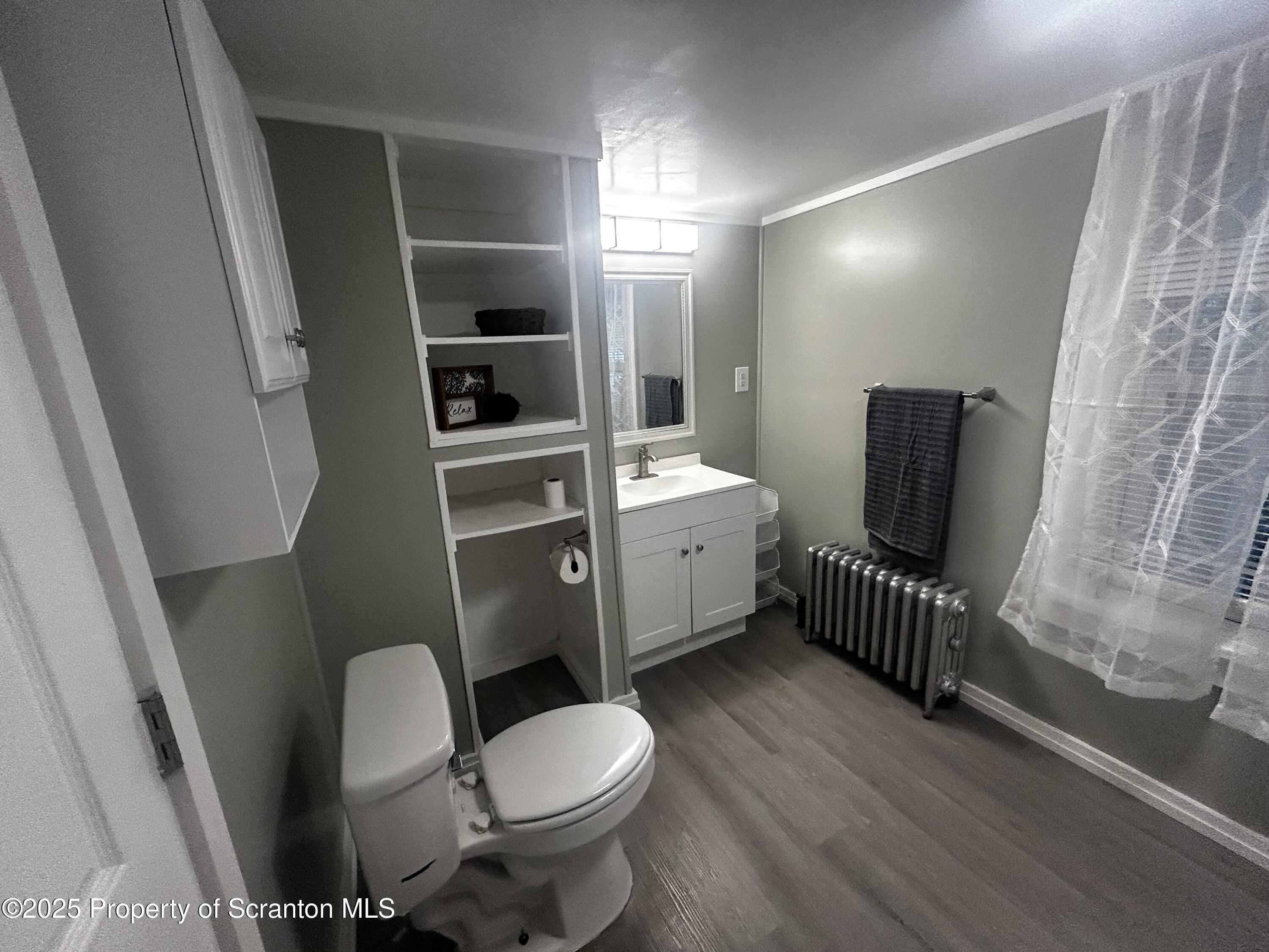 1214 Mine Street Old Forge, PA 18518 - Photo 17 of 21 a bathroom with a toilet a sink and mirror