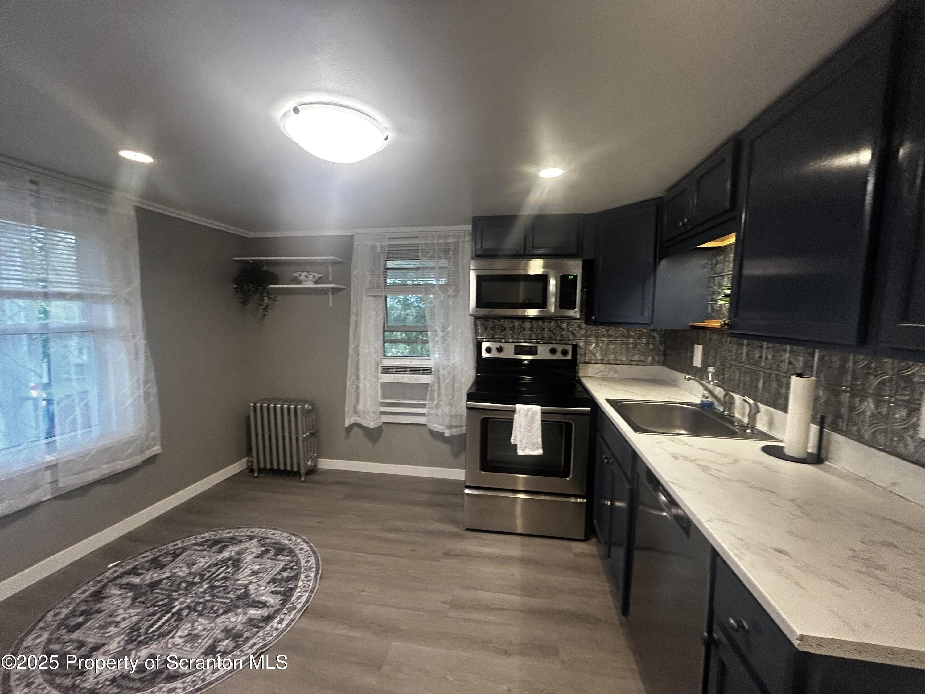 1214 Mine Street Old Forge, PA 18518 - Photo 9 of 21 a kitchen with stainless steel appliances granite countertop a sink stove and refrigerator