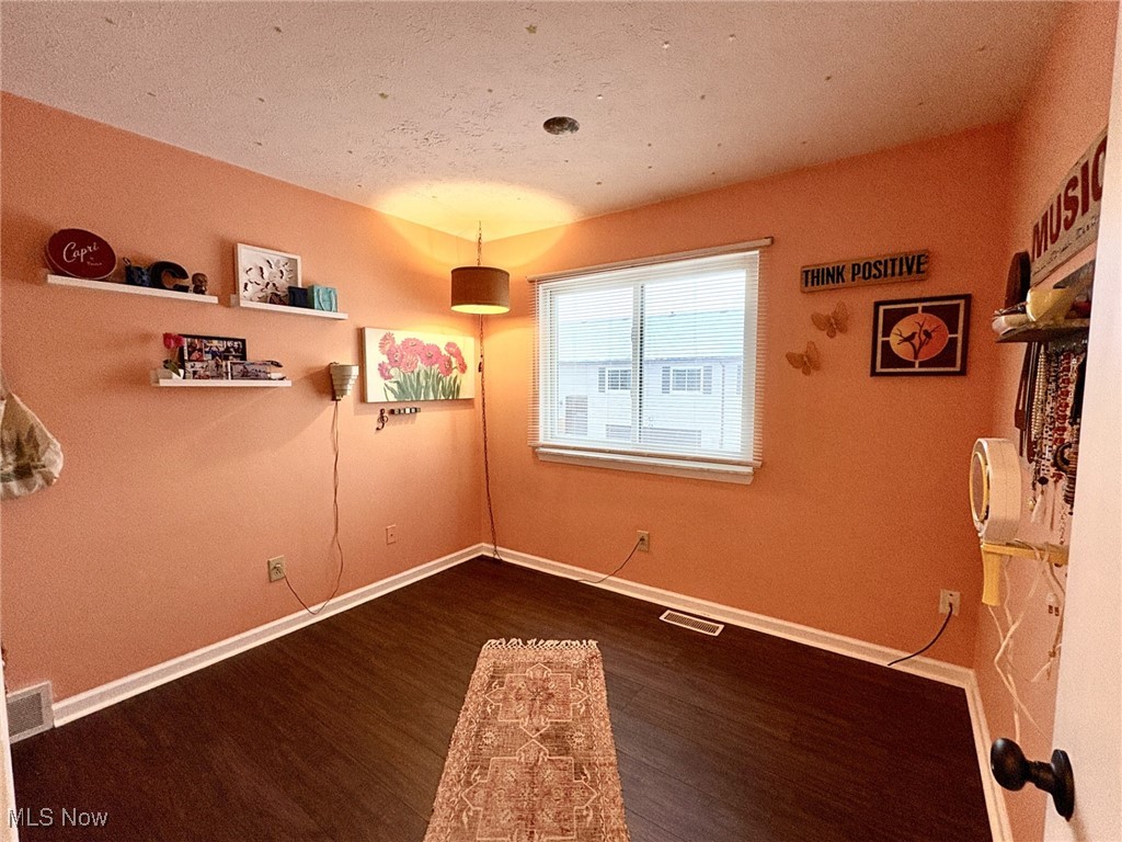 4015 Marks Road, Unit 3C Medina, OH 44256 - Photo 17 of 36 Unfurnished room featuring dark hardwood / wood-style flooring and a textured ceiling