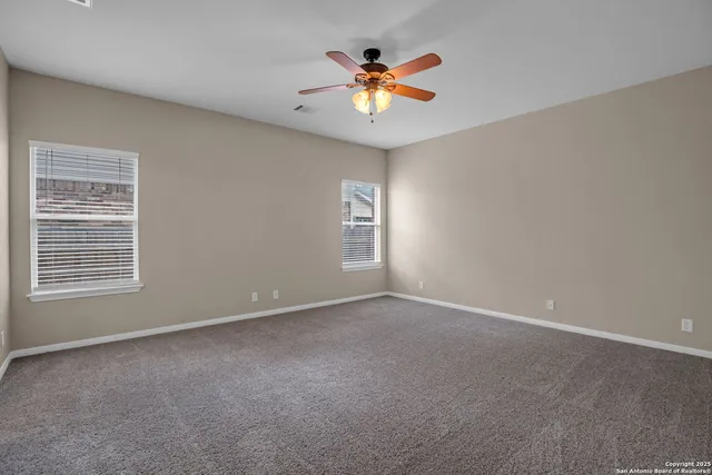 a bathroom with a granite countertop sink a toilet and a large mirror