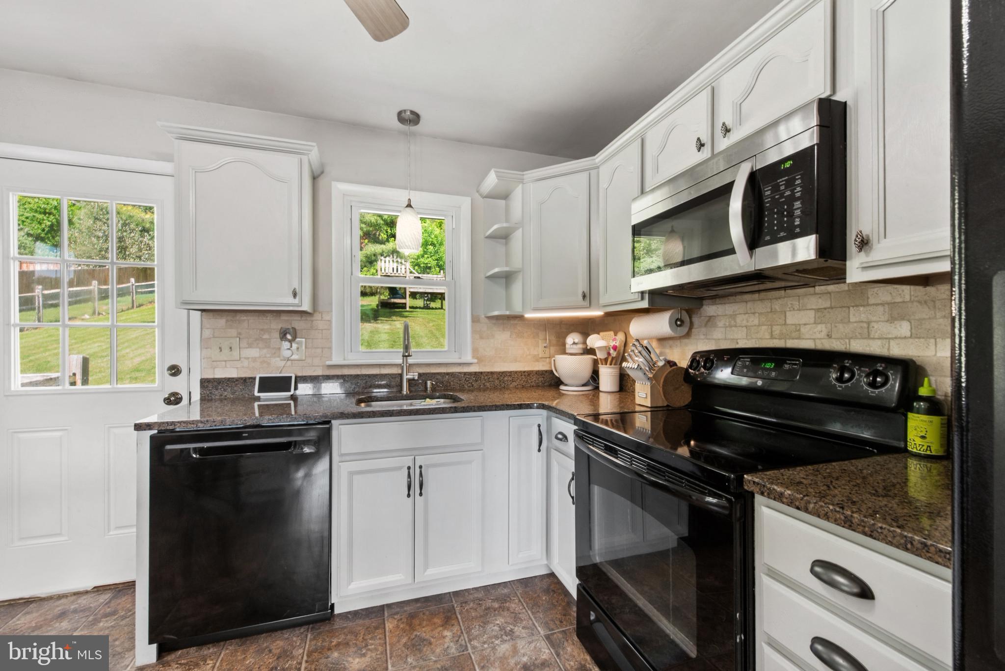 3242 Lineboro Road Manchester, MD 21102 - Photo 13 of 30 a kitchen with stainless steel appliances and white cabinets