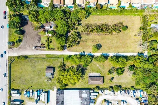 an aerial view of a residential houses with outdoor space and swimming pool