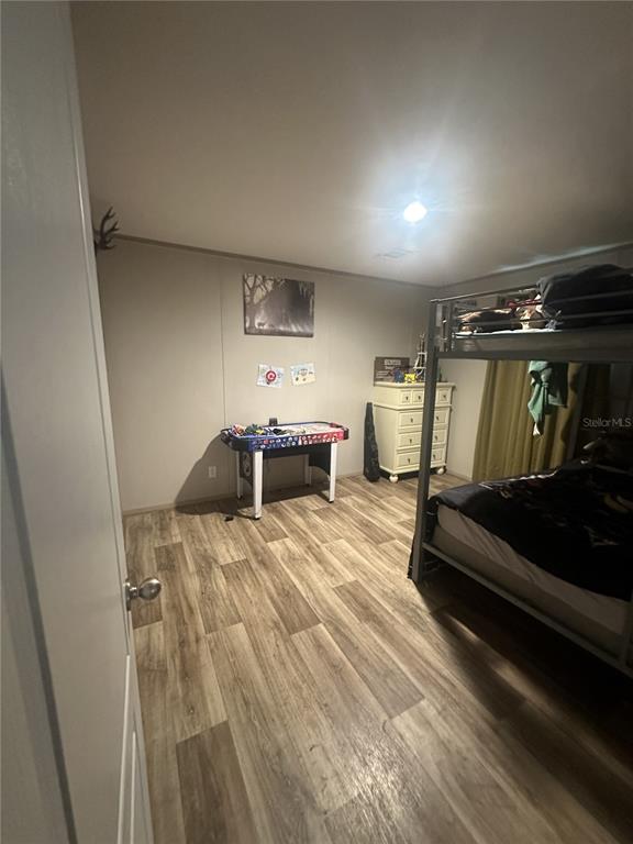 42833 Cooter Pond Road DeLand, FL 32720 - Photo 11 of 16 a bed room with furniture and view of gym equipment