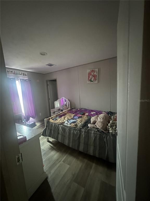 42833 Cooter Pond Road DeLand, FL 32720 - Photo 12 of 16 a bedroom with a bed and a window