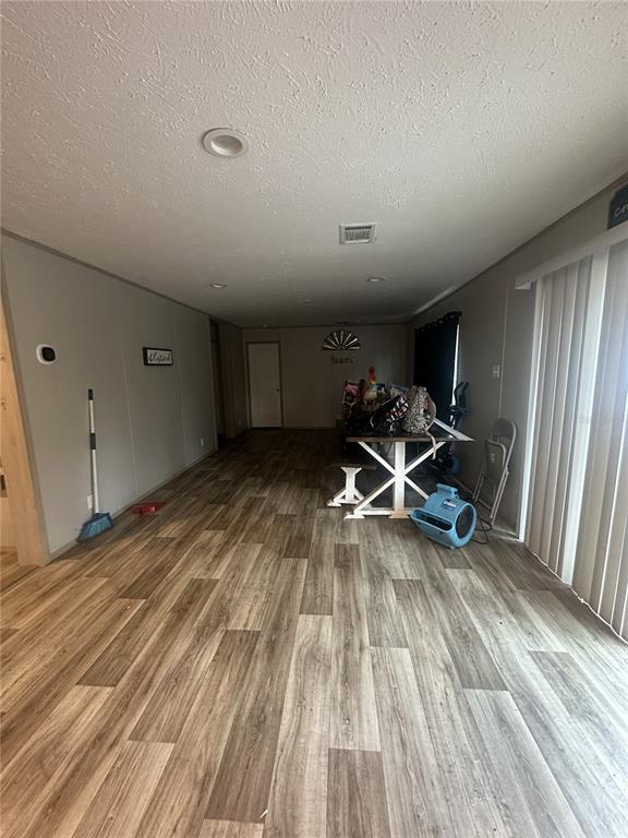 42833 Cooter Pond Road DeLand, FL 32720 - Photo 9 of 16 a view of a room with wooden floor and chairs
