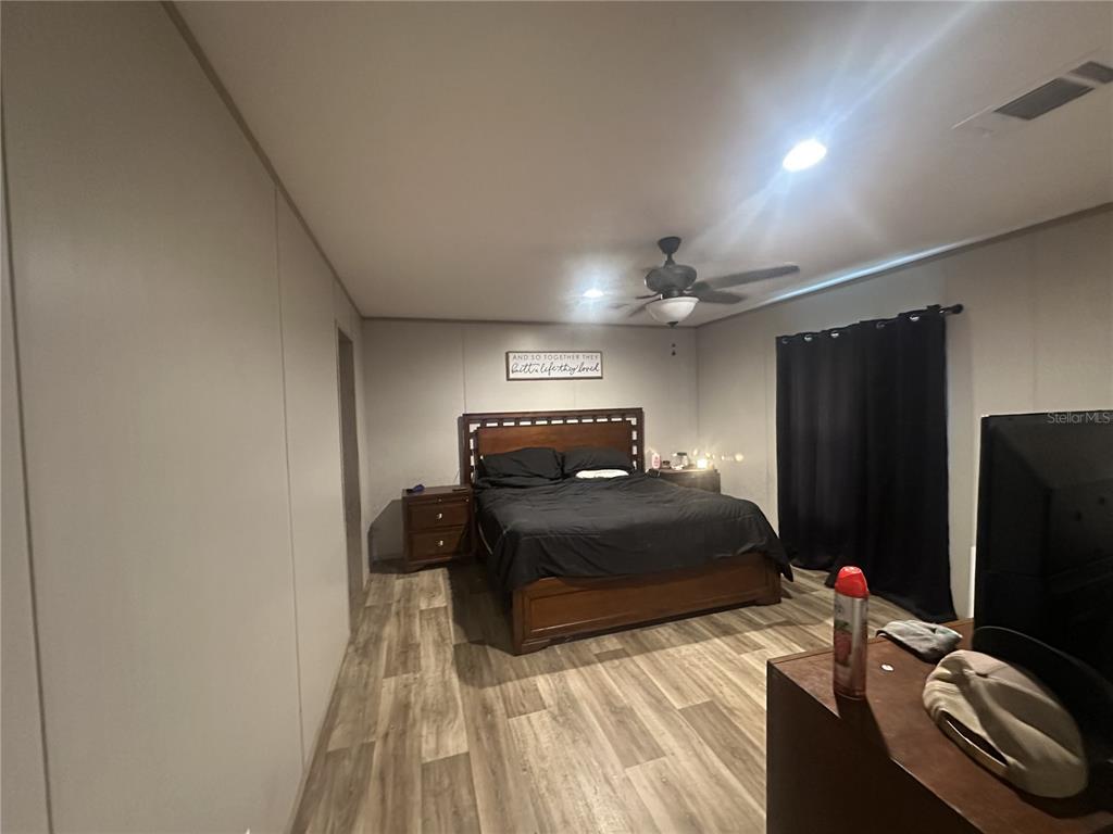 42833 Cooter Pond Road DeLand, FL 32720 - Photo 10 of 16 a room with a bed and a flat screen tv