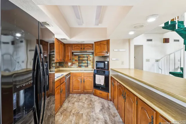 a large kitchen with stainless steel appliances lots of counter top space