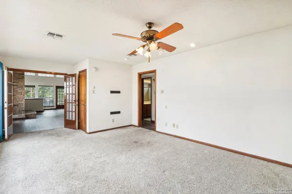 a view of a livingroom with a ceiling fan and window