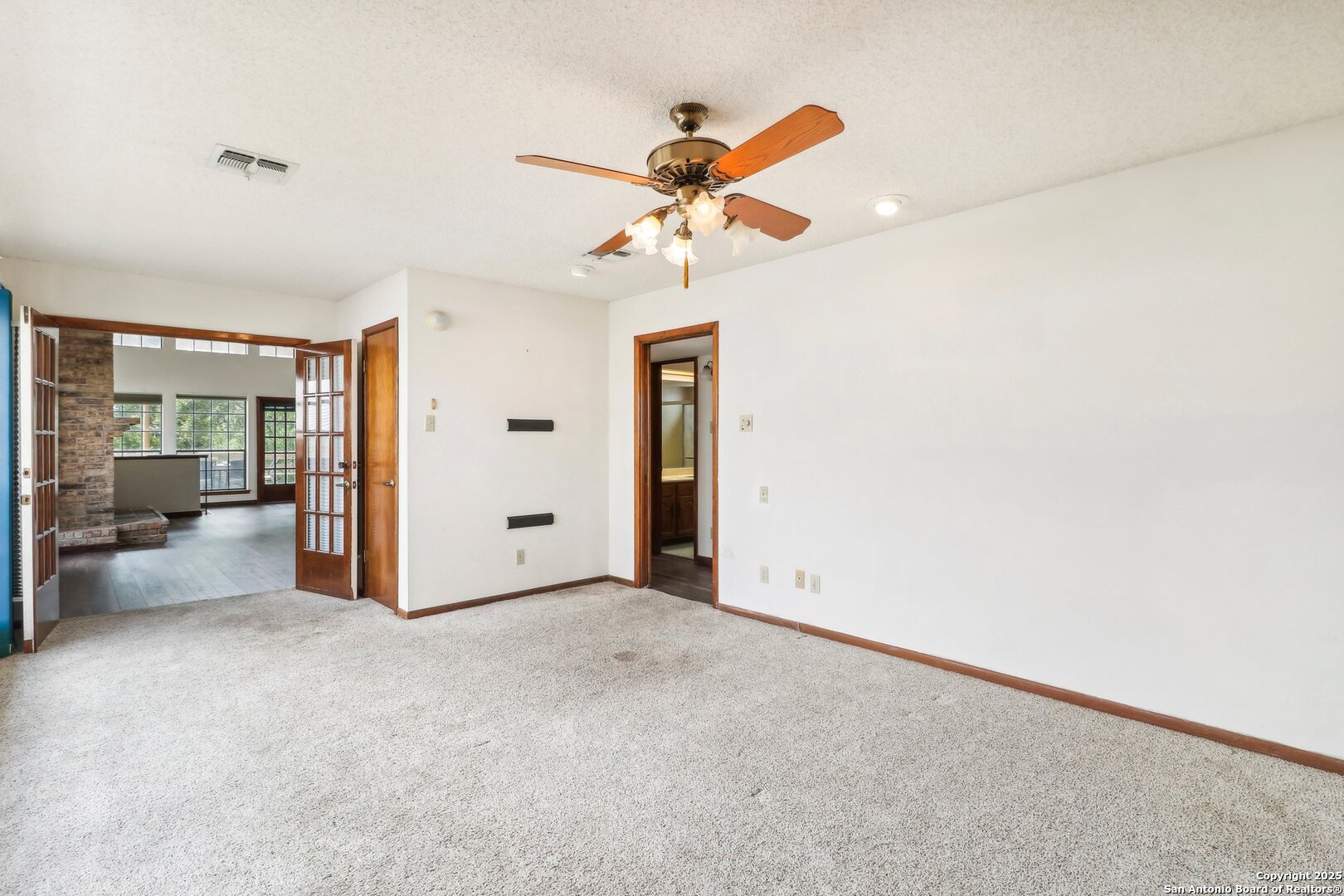 1551 Pebble Beach Road Lakehills, TX 78063 - Photo 25 of 46 a view of a livingroom with a ceiling fan and window