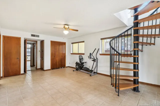 a view of a livingroom with furniture and staircase