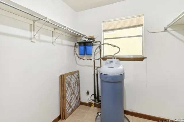 a view of storage and utility room with racks on the wall