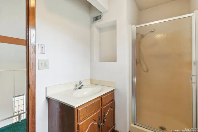 a bathroom with a sink and mirror