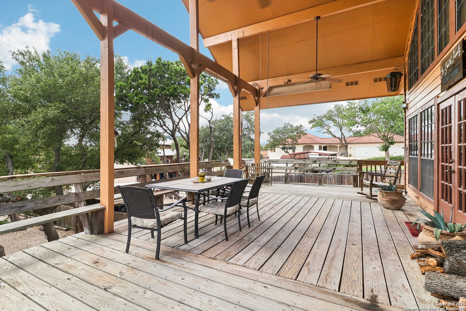 1551 Pebble Beach Road Lakehills, TX 78063 - Photo 37 of 46 a view of a patio with table and chairs and wooden floor