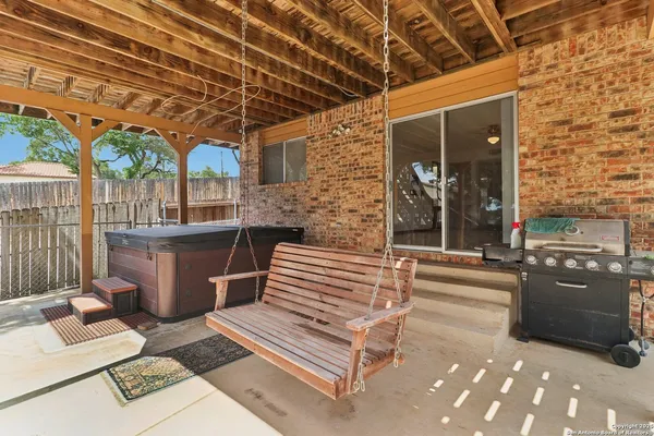a view of a patio with table and chairs barbeque oven with wooden fence