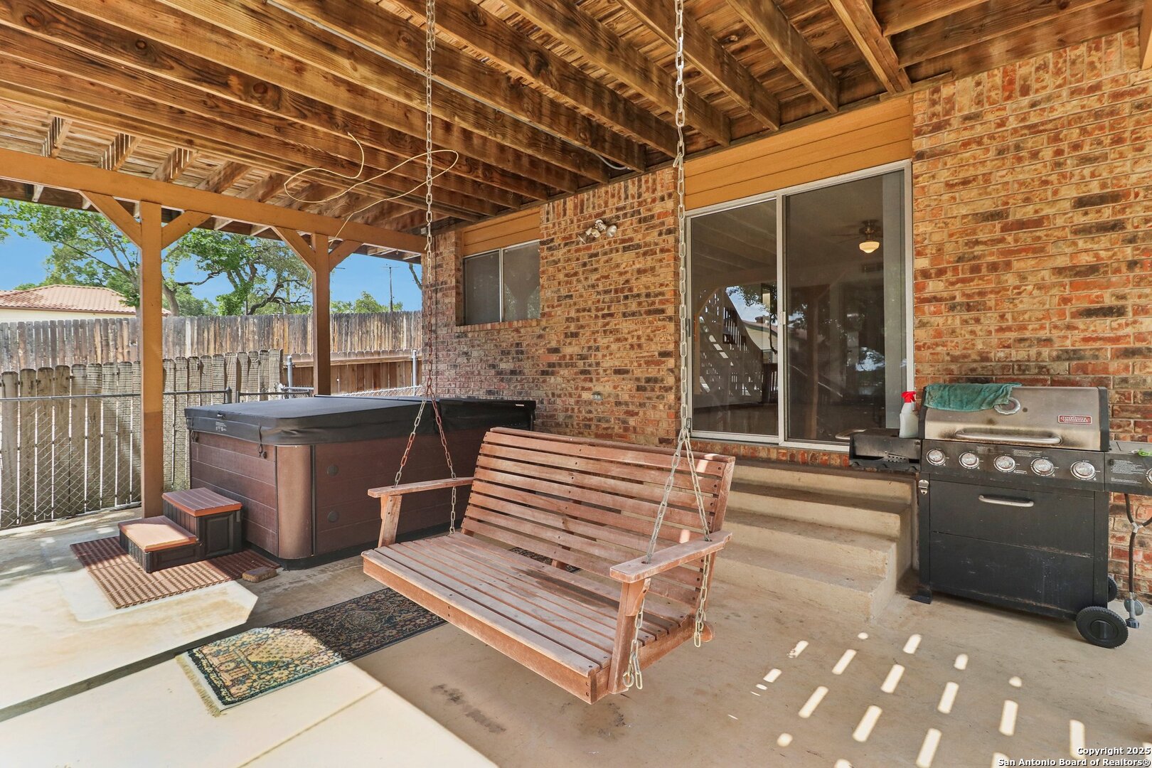 1551 Pebble Beach Road Lakehills, TX 78063 - Photo 38 of 46 a view of a patio with table and chairs barbeque oven with wooden fence