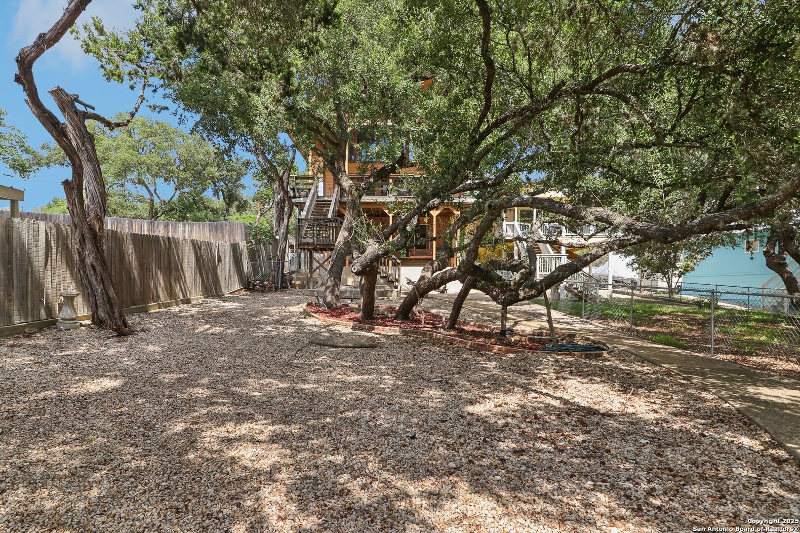 1551 Pebble Beach Road Lakehills, TX 78063 - Photo 42 of 46 a view of a tree in the middle of a yard
