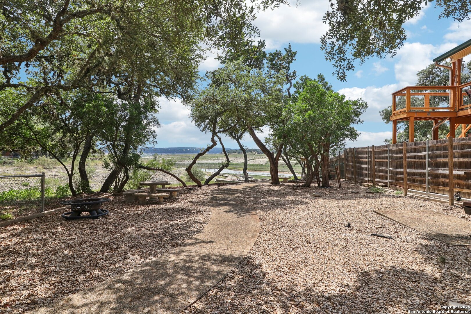 1551 Pebble Beach Road Lakehills, TX 78063 - Photo 43 of 46 a view of outdoor space with deck and trees