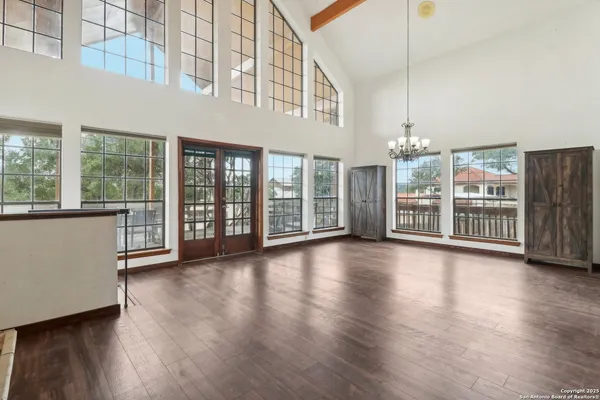 a view of a big room with wooden floor windows and a living room