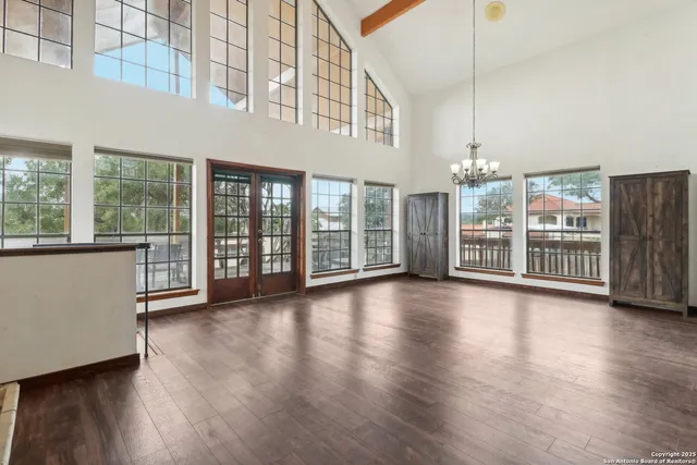 a view of a big room with wooden floor windows and a living room