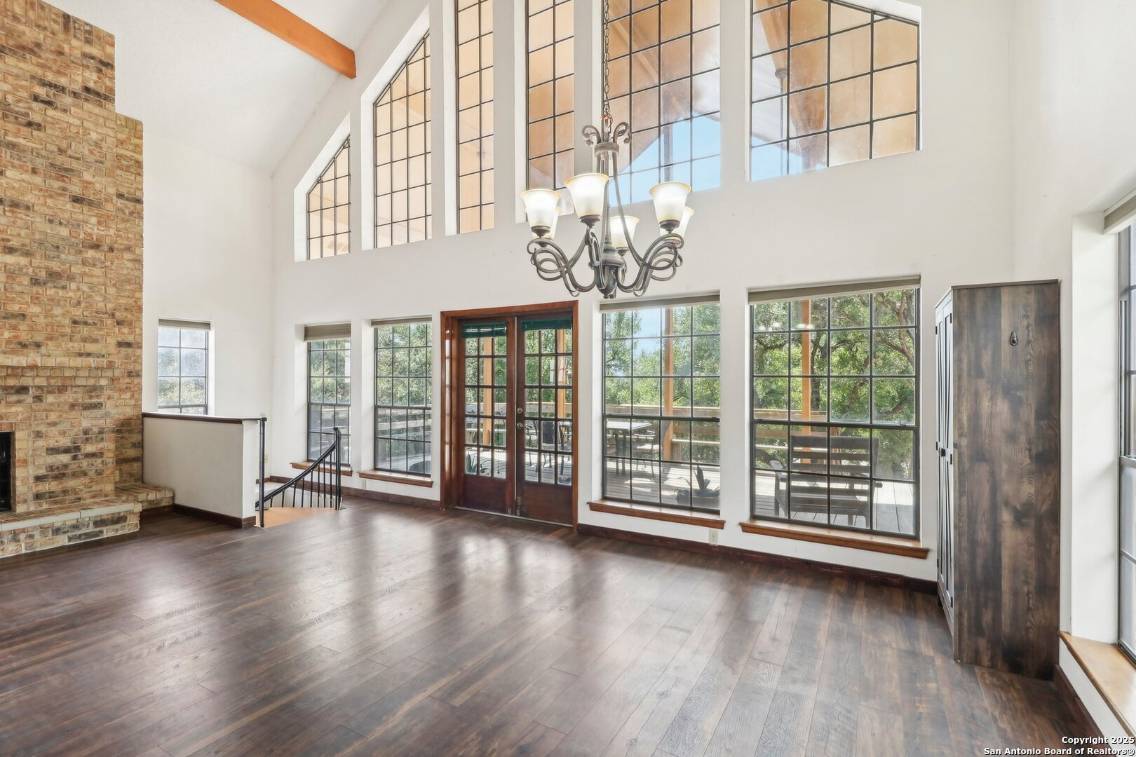 1551 Pebble Beach Road Lakehills, TX 78063 - Photo 6 of 46 a view of an empty room with wooden floor and a window