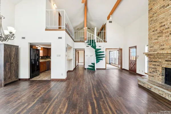 wooden floor in an empty room with a fireplace