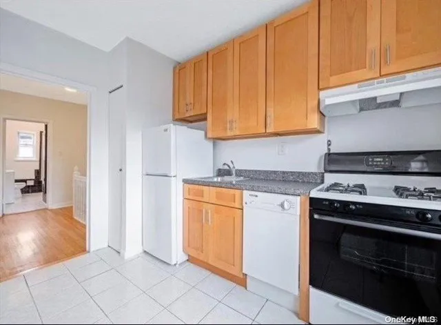 a kitchen with stainless steel appliances granite countertop a stove and a refrigerator