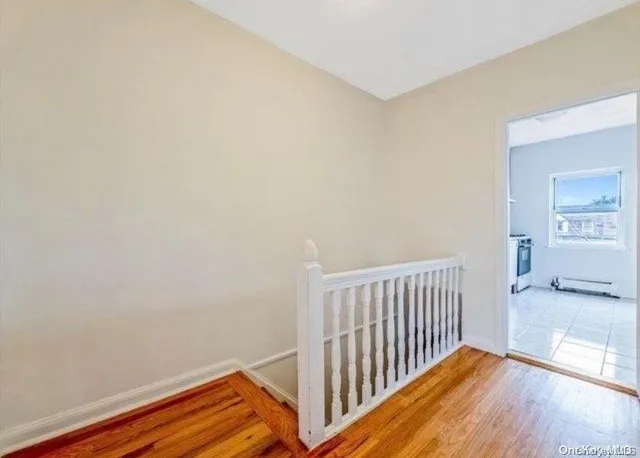 a view of a room with wooden floor