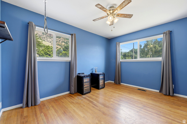 1486 3rd Street Ogden, UT 84404 - Photo 10 of 26 Spacious room featuring wood-finish flooring and two large windows