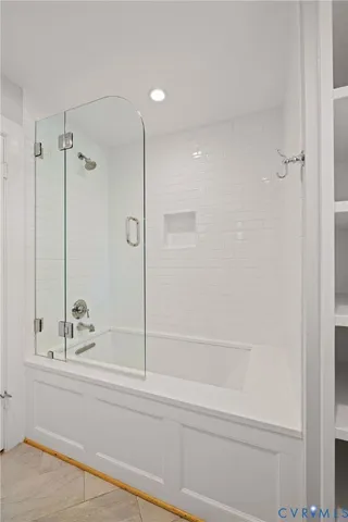 a bathroom with a shower and a bath tub