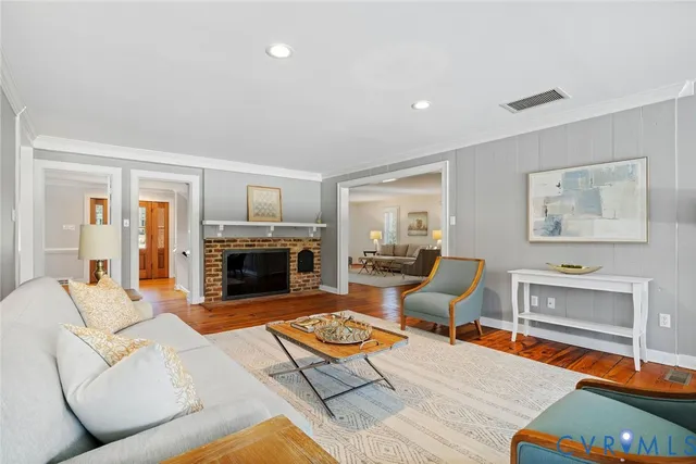 a living room with furniture fireplace and flat screen tv