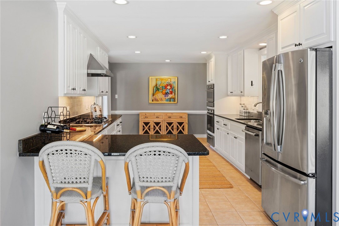 9804 Kingsbridge Road Henrico, VA 23238 - Photo 20 of 50 a kitchen with stainless steel appliances granite countertop a refrigerator and a stove top oven