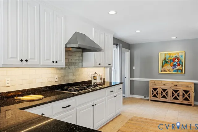 a kitchen with stainless steel appliances granite countertop a sink and a stove