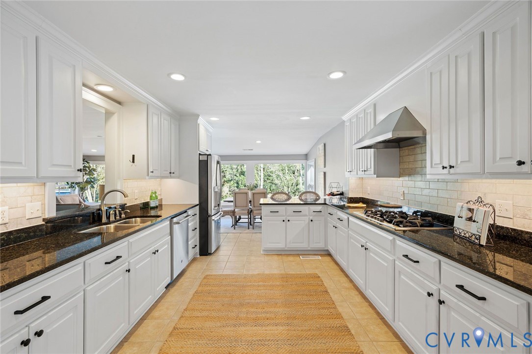 9804 Kingsbridge Road Henrico, VA 23238 - Photo 24 of 50 a kitchen with a sink stove and cabinets
