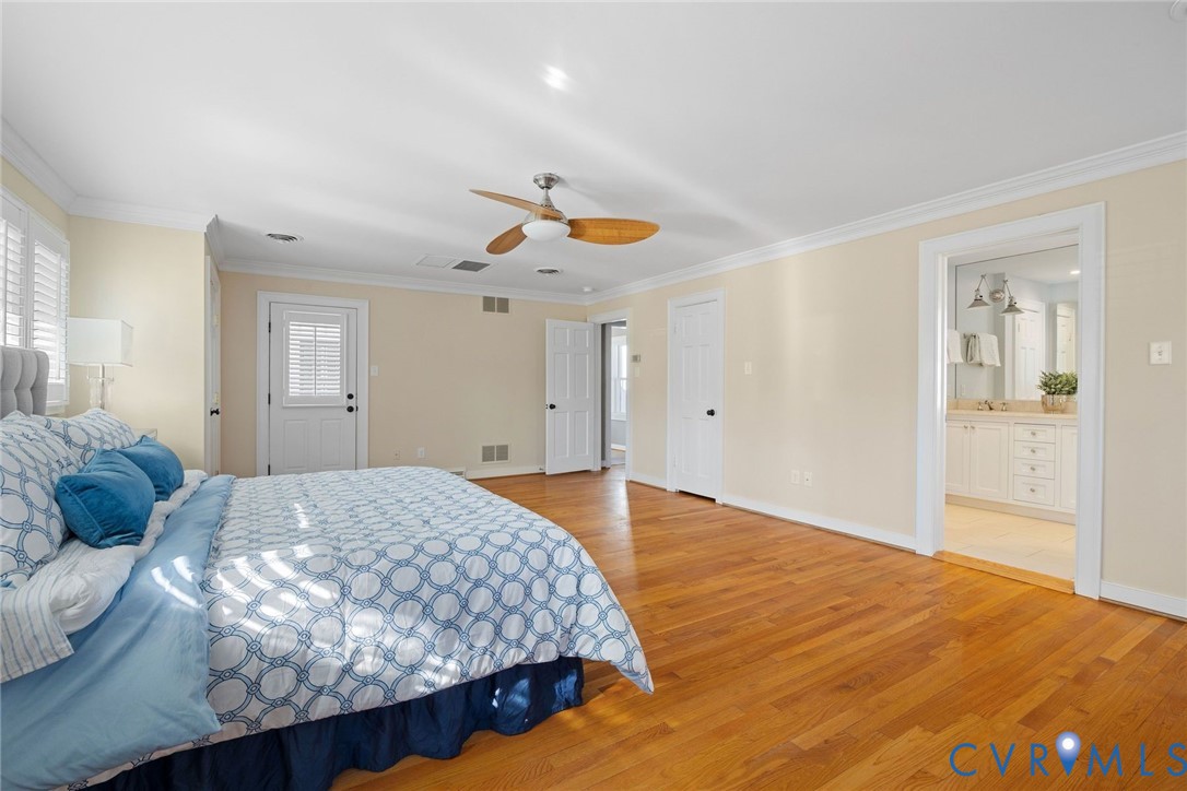 9804 Kingsbridge Road Henrico, VA 23238 - Photo 26 of 50 a bedroom with a large bed and chandelier
