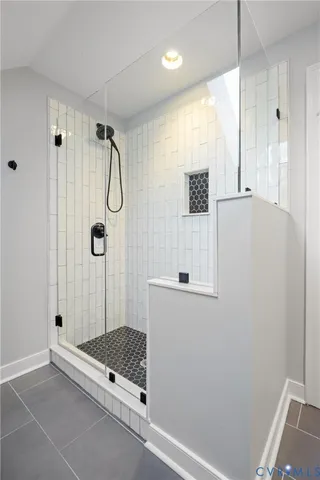 a bathroom with a shower and a window