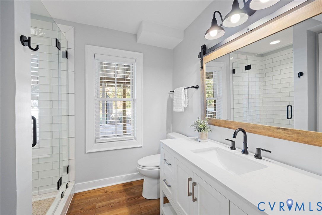 9804 Kingsbridge Road Henrico, VA 23238 - Photo 40 of 50 a bathroom with double vanity sink a mirror and a shower