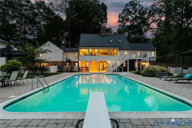 an outdoor space with swimming pool and furniture