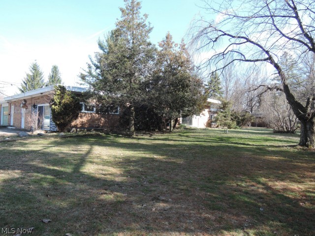 13091 County Line Road Chesterland, OH 44026 - Photo 11 of 23 Mature trees and a rhododendron give privacy to the front of the house.