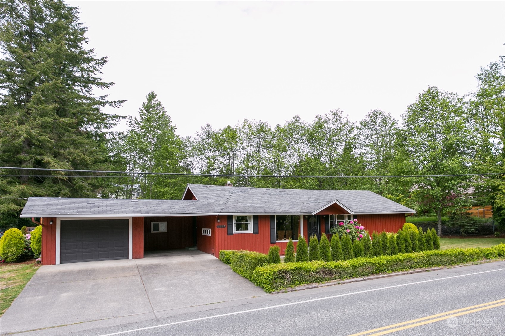 a front view of a house with a garden