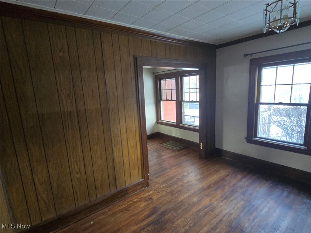 2048 Rossmoor Road Cleveland Heights, OH 44118 - Photo 14 of 29 Unfurnished room featuring dark wood-style floors and wood walls