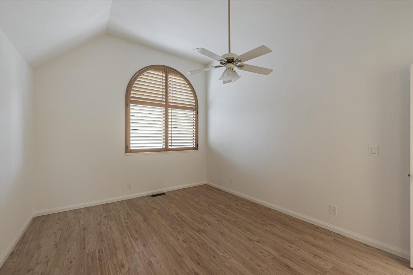 720 Natalie Drive Morgan Hill, CA 95037 - Photo 16 of 35 an empty room with wooden floor a ceiling fan and windows