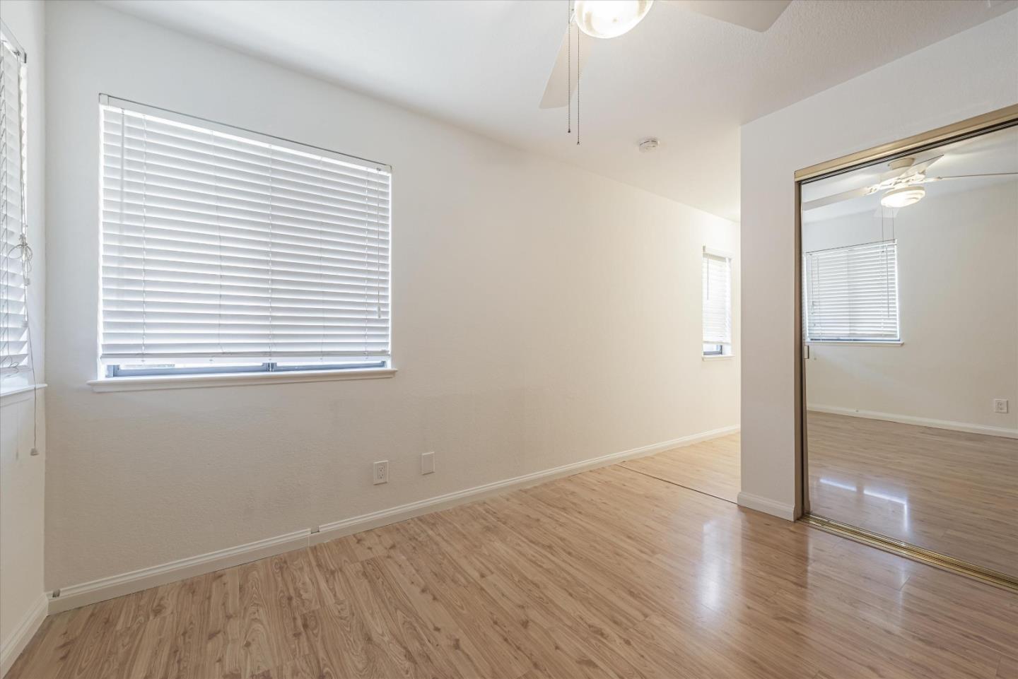 720 Natalie Drive Morgan Hill, CA 95037 - Photo 21 of 35 an empty room with wooden floor and windows