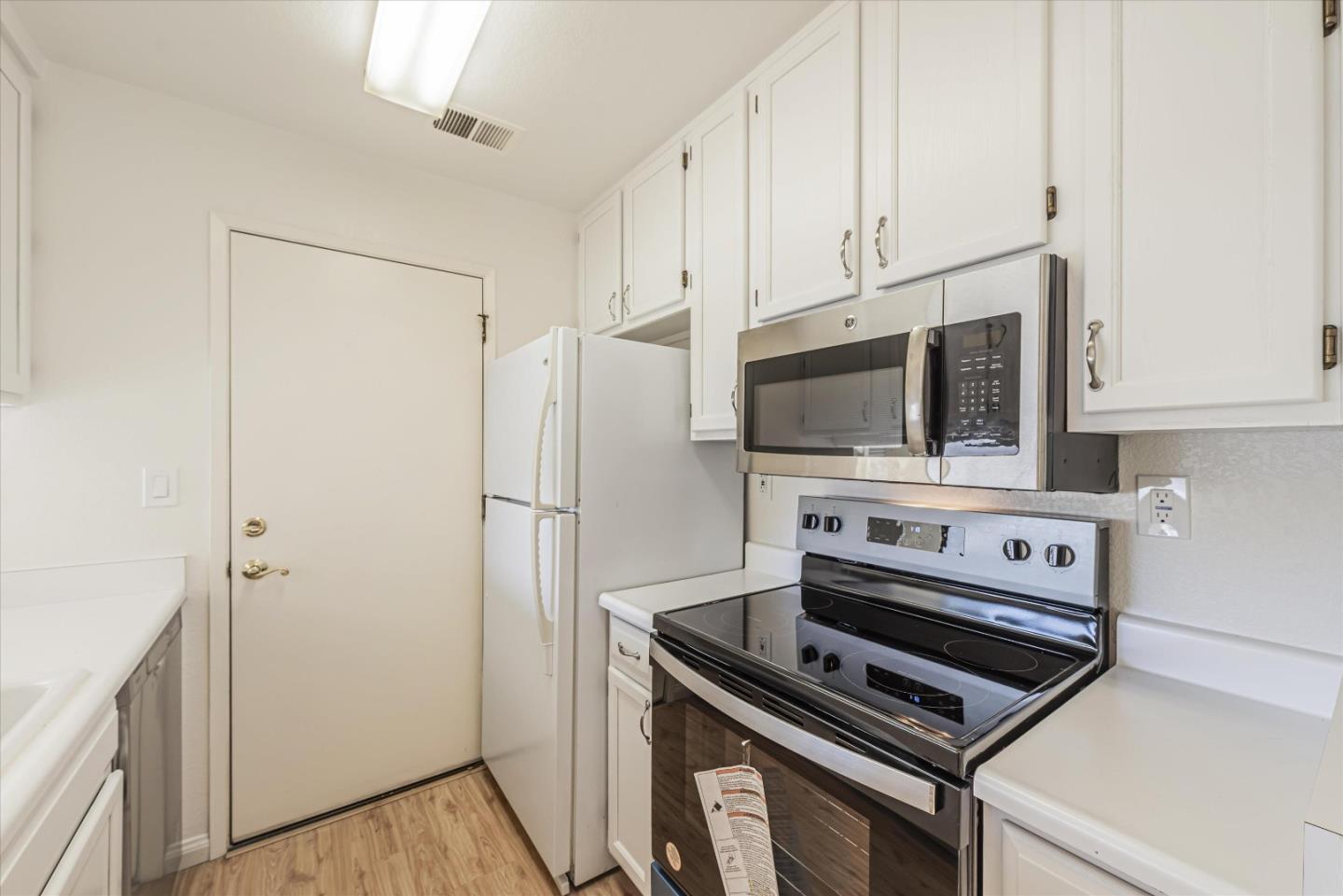 720 Natalie Drive Morgan Hill, CA 95037 - Photo 9 of 35 a kitchen with a stove and a microwave