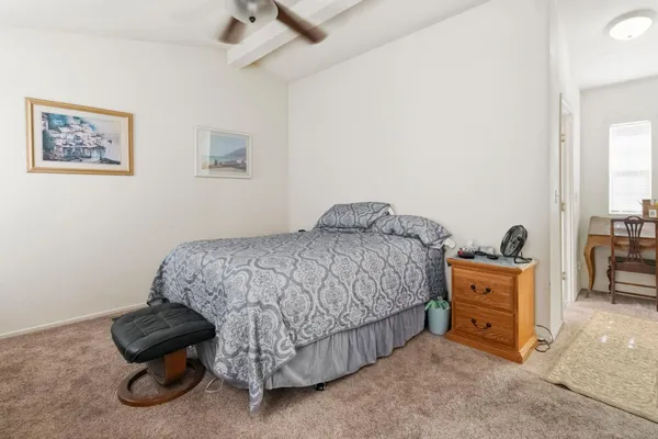 a bedroom with a bed and a chair