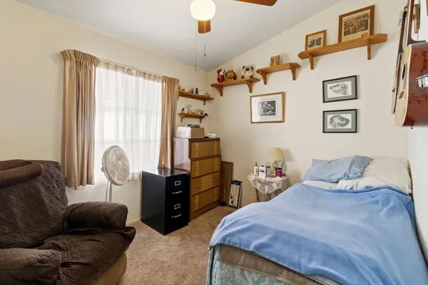 a bedroom with furniture and a window
