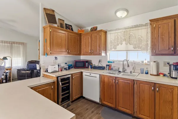a kitchen with stainless steel appliances granite countertop a sink a stove and cabinets