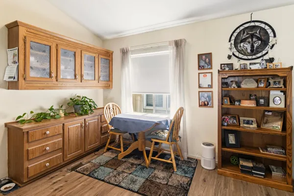a view of a dining room with furniture and wooden floor