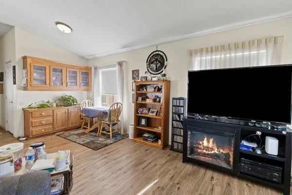 a living room with furniture a flat screen tv and a fireplace