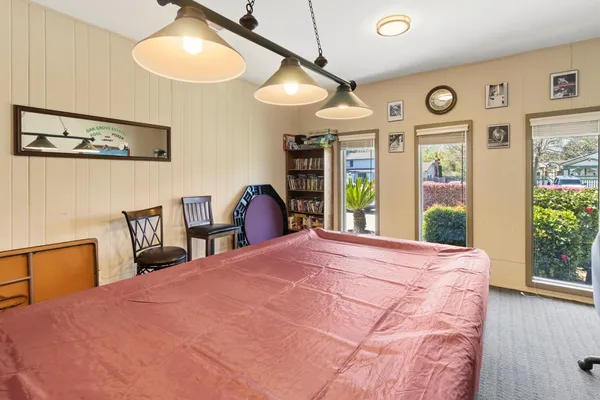 a bedroom with a bed mirror and window