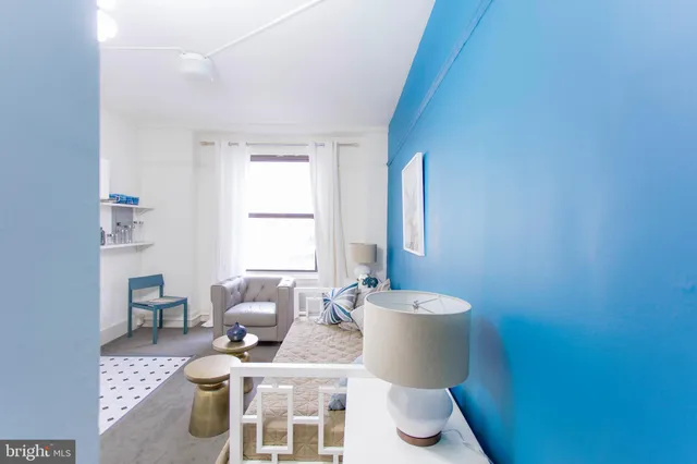 a living room with furniture a window and a sink